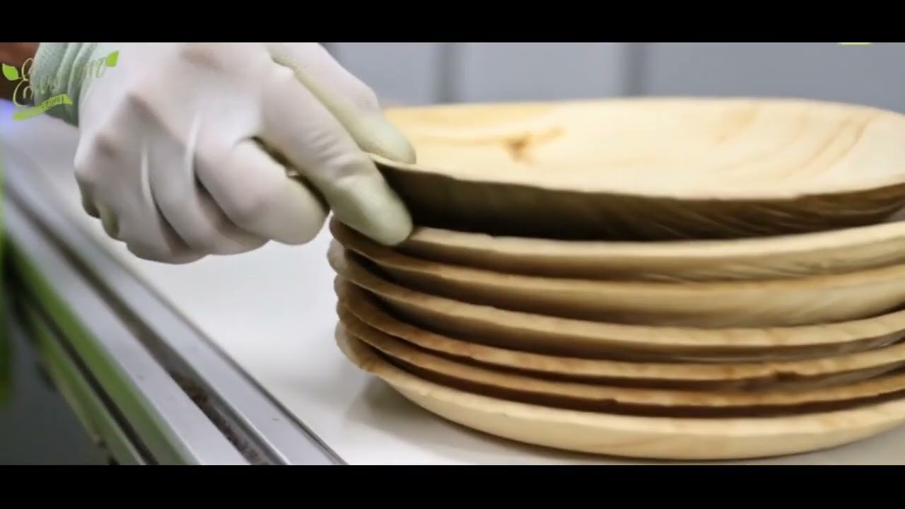Heat pressing areca palm leaf sheaths into plates at 200°C in CNC hydraulic moulds